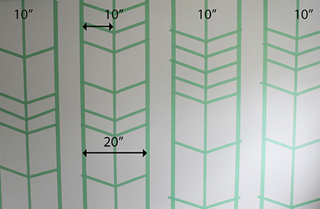 wall with arrow patterns taped off and measurements