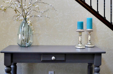 front view of refinished console table with decor