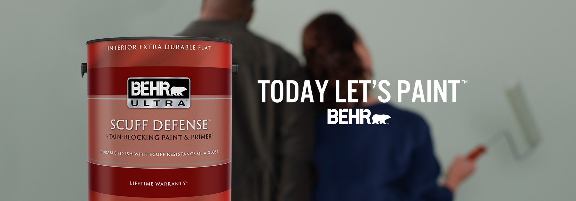 Couple getting ready to paint with a can of BEHR Ultra Scuff Defense Extra Durable Flat interior paint and the words Today Let's Paint in foreground.