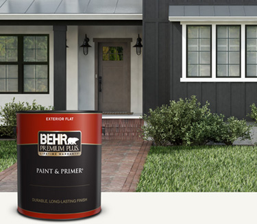 Mobile version of black and white house exterior with a can of Behr Premium Plus Exterior Flat in foreground