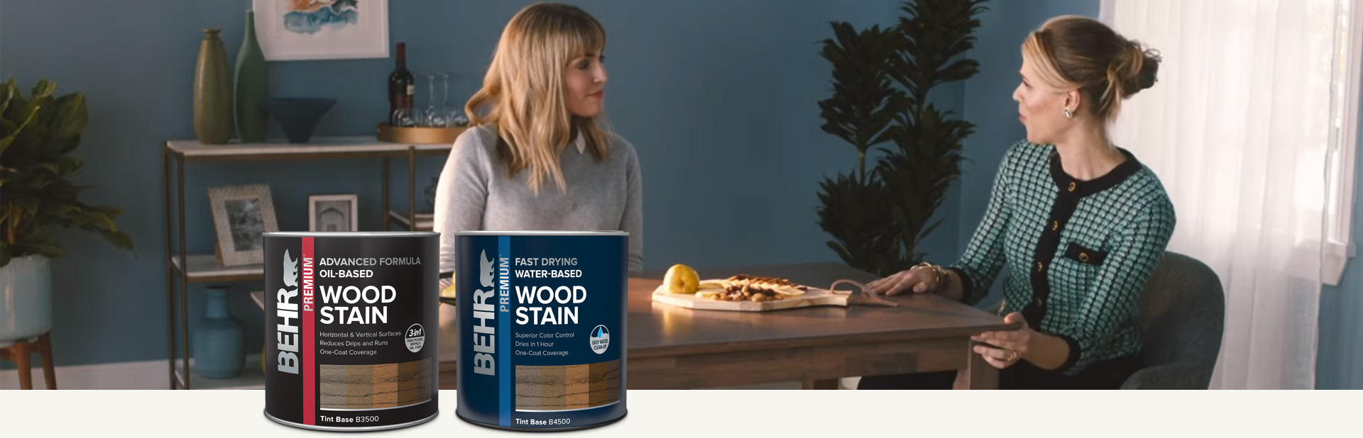 Two ladies sitting at stained dining table with Behr interior wood stain products in foreground