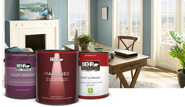 1 gallon cans of Premium Plus Interior Flat, Behr Ultra Scuff Defense interior Eggshell, Marquee Interior Matte paints in foreground of casual blue dining room.