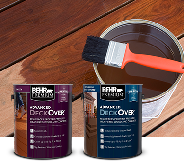 Mobile version of two cans of Behr Premium Advanced DeckOver Coating with a wooden deck, product can, and brush in the background