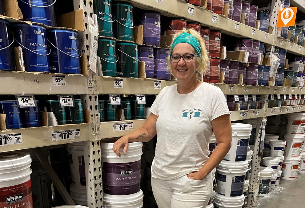 A woman painter purchasing paint at The Home Depot store