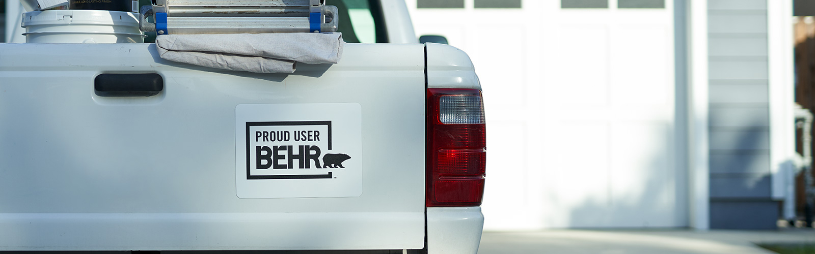 landscape image of a back of a truck with a PROUD USER BEHR magnet sign