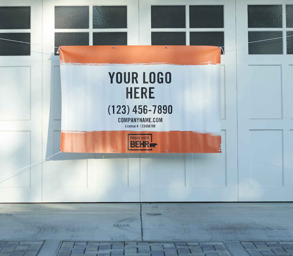 An image of a banner that is displayed in front of a garage door. The banner is printed with the words YOUR LOGO HERE - (123) 456-7890 - company.com - PROUD USER BEHR.