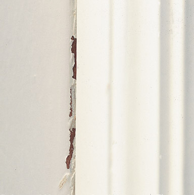 Close up image of the result when two painted surfaces are pressed together, one of the surface looks like the paint is peeling.