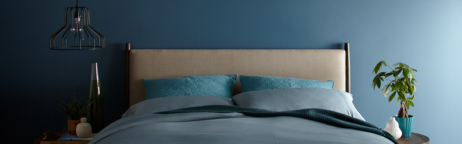 image of a bed with a blue wall