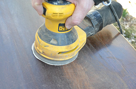 surface being sanded with electric sander