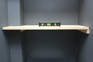 unfinished shelf with level