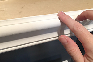 decorative trim being added to front edge of shelf