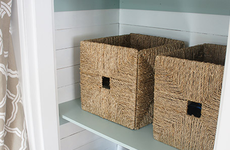 decorative storage baskets on closet shelf