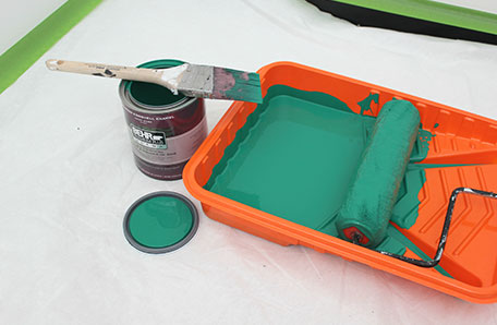 Green color with paint brush and Behr can