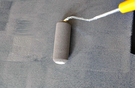 gray paint being applied with mini roller