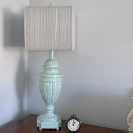 finished lamp with clock next to it on table