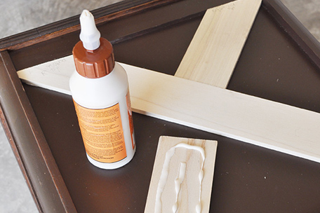 wooden accent pieces being glued to side table
