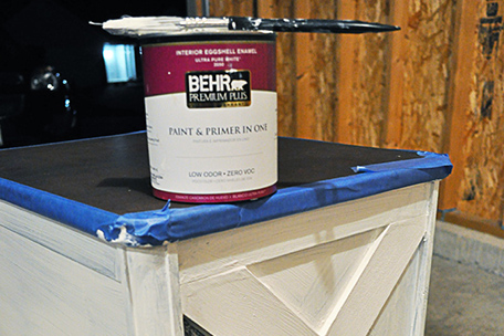 side table being painted and paint can on top