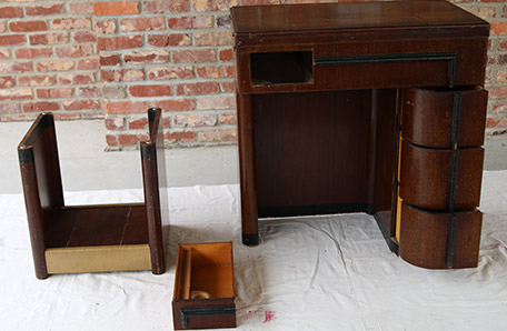 sewing desk with drawers pulled out and chair to the side