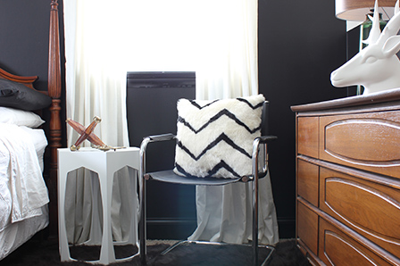 The solid white curtains and black-and-white pillow pick up the new color scheme