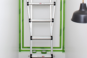 wall with painters tape to form frame for accent wall