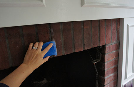 Cleaning brick of the fireplace prior to painting