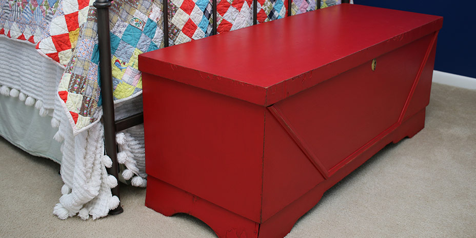 finished red blanket chest at foot of bed