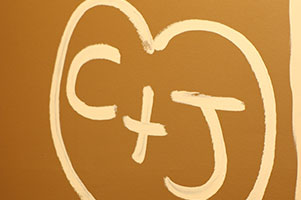 initials and heart painted on wall