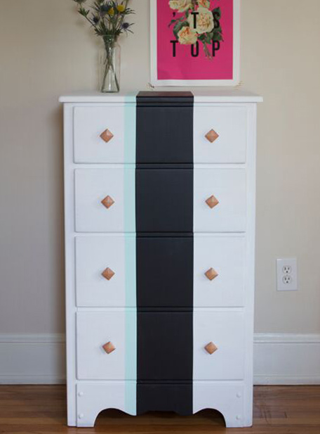 full length view of refinished chest of drawers with vertical stripes down middle and decor