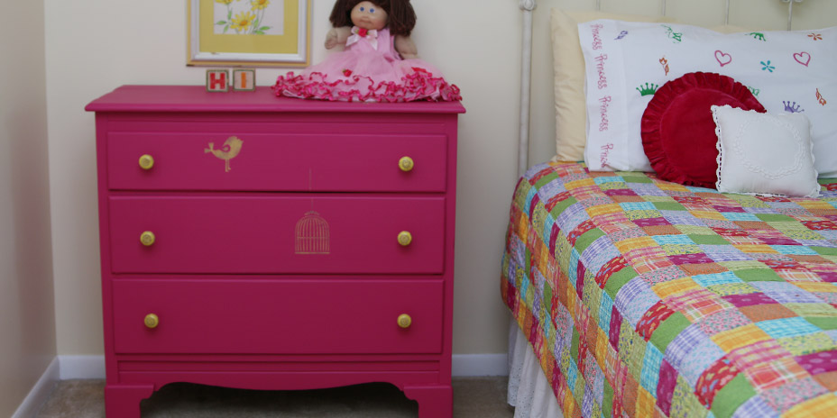 repainted dresser with decor next to bed