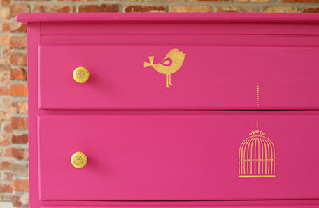 close up of front of dresser with bird and cage stenciling