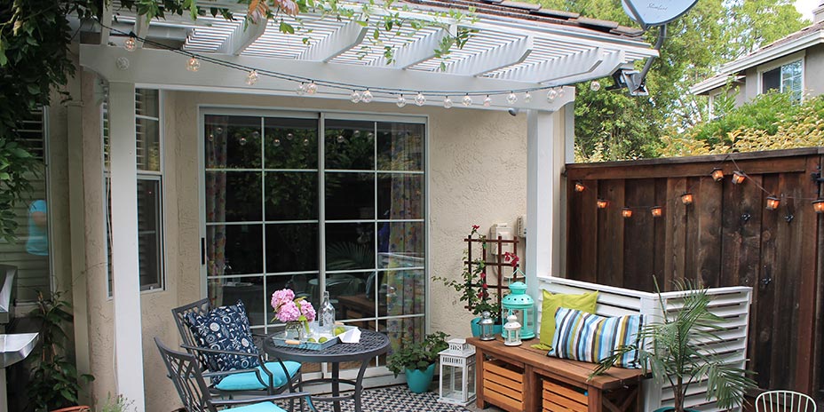 back patio with painted pergola and patio furnishings