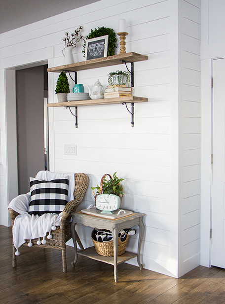finished shiplap wall with sitting area shelving and decor