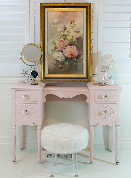 Finished vanity painted pale pink with furnishings and decor