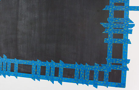 chalkboard painted area with sections of border taped off