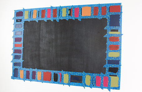 chalkboard with taped and painted border drying