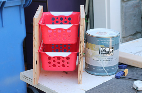 partially assembled storage with plastic bins