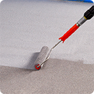 image of a concrete floor being coated with BEHR Premium Granite Grip