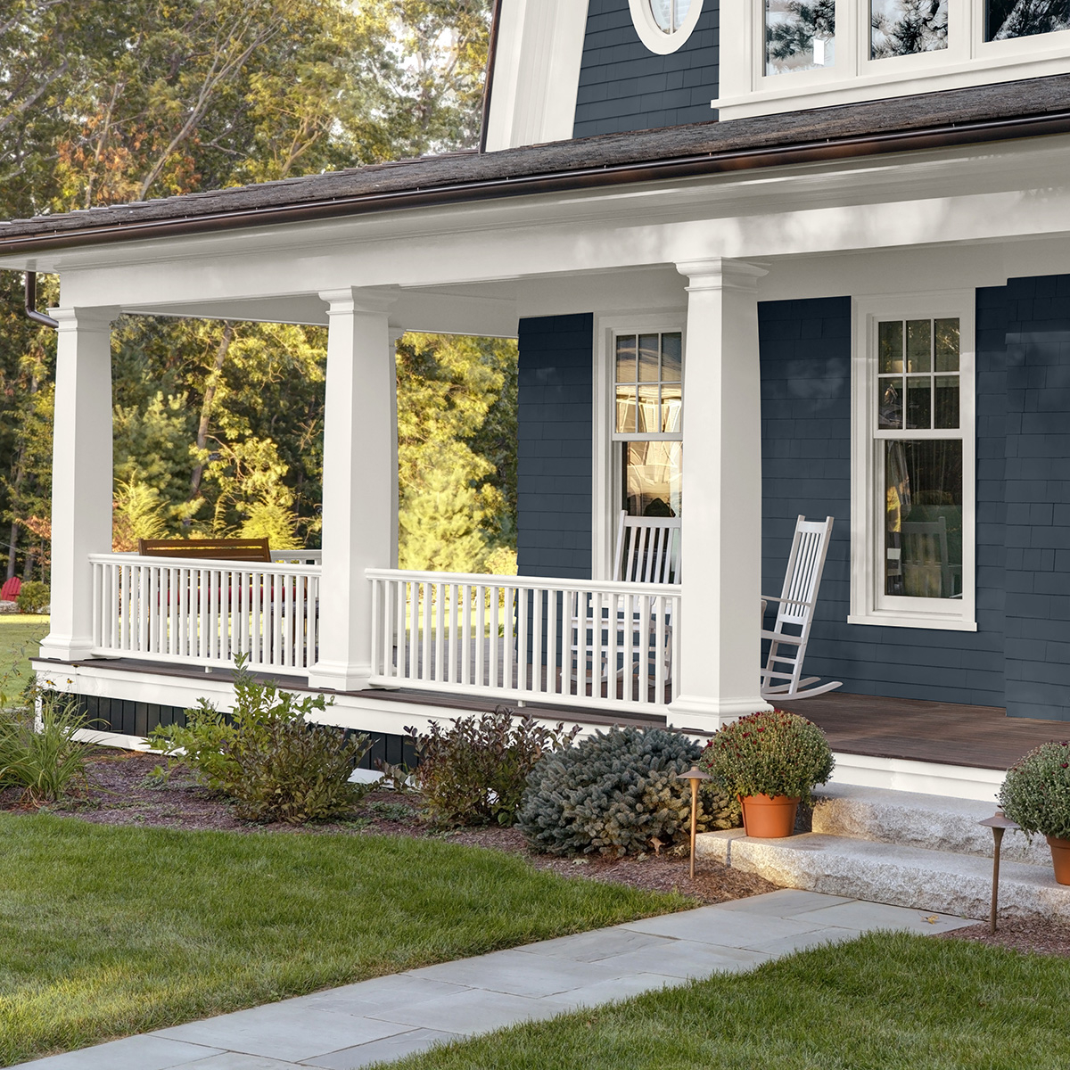 A blue and white house exterior painted with Behr Dynasty Exterior paint