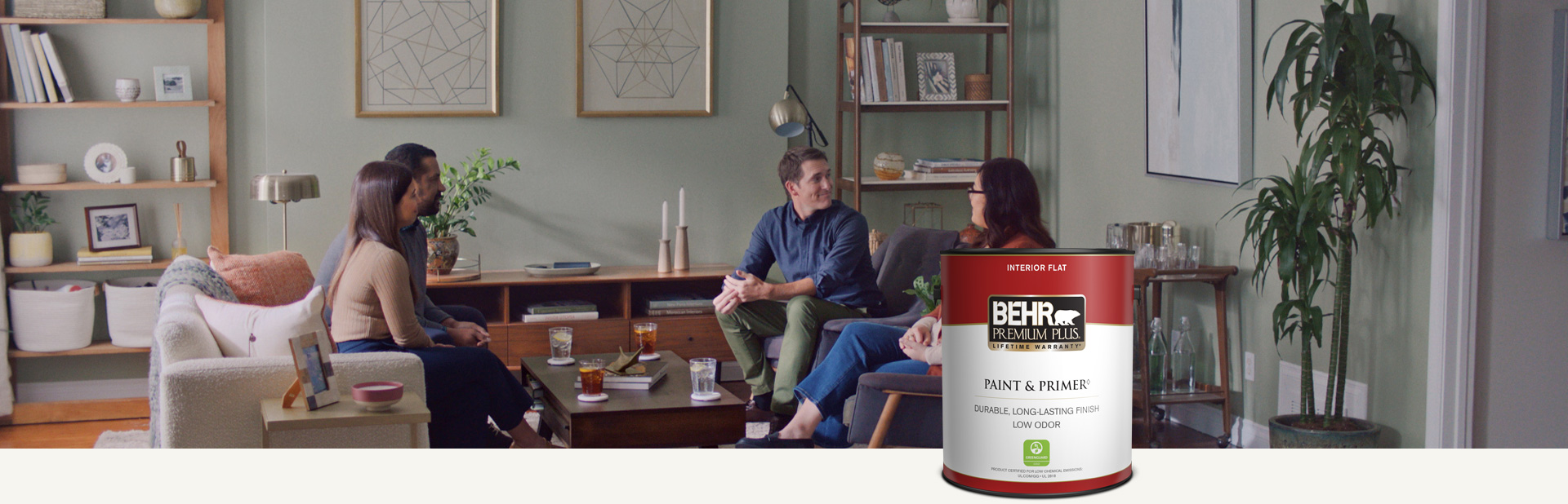 Family sitting in a painted living room with a Behr Premium Plus Interior Flat Paint