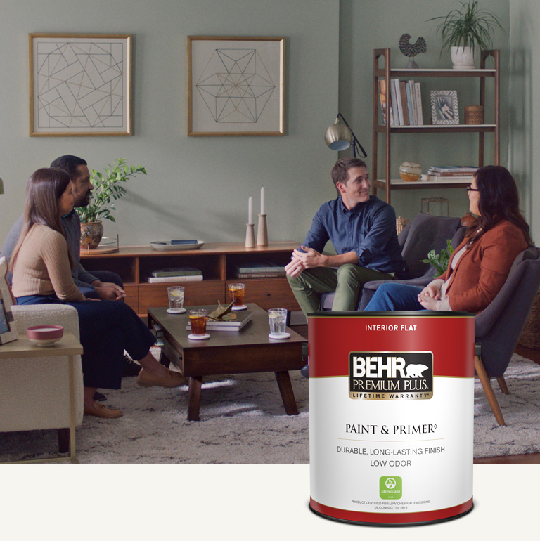 Mobile version of a family sitting in a painted living room with a Behr Premium Plus Interior Flat Paint