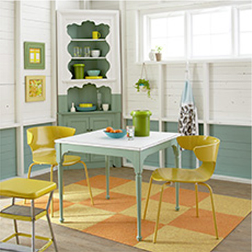 Dining room with green table and 2 yellow chairs and a yellow highchair