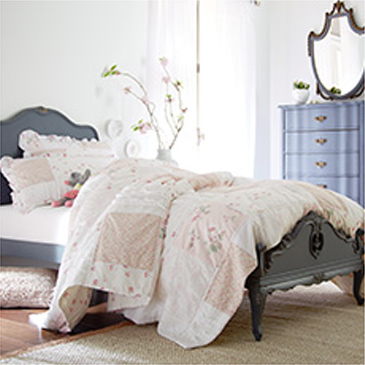 Gray bed with white comforter and matching dresser
