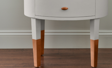 Close up of spray painted side table showcasing advanced hide