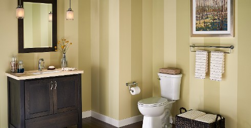 Soothing styled bathroom with light brown, white, brown vertically striped walls, and dark brown wooden vanity.