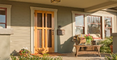 Outdoor porch with light green walls, tan trim, and red accents.