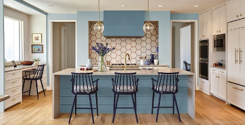 Relaxed kitchen with light blue on accent wall, white on ceiling and cabinets and honeycomb backsplash