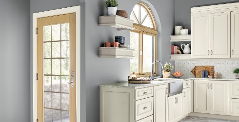 Traditional styled kitchen with blue gray on walls, white on cabinets, and granite counter tops