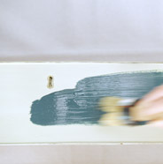 Person painting furniture with BEHR Chalk Decorative Paint
