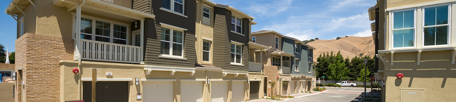 Large image of an exterior of a multi-family home properties next to each other.