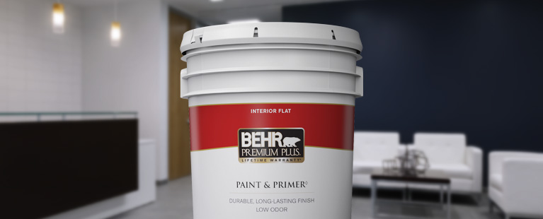 Image of a 5 gallon can shot of BEHR PREMIUM Plus Interior flat. The background is of a reception area.